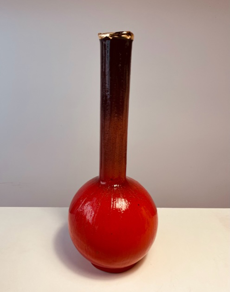 Glossy red glazed ceramic bottle. Third-fire pure gold decoration on rim. Height 46 cm.
